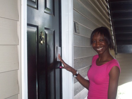 Ebony putting flyers on apartment doors